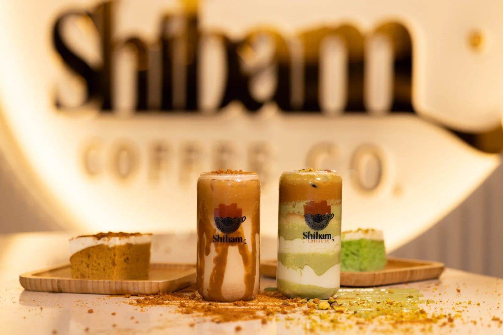 Shibam drinks and pastries arranged on a warm café table