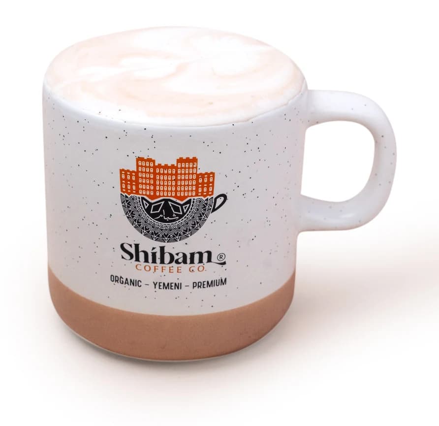 Babyccino with milk foam in a Shibam Coffee mug